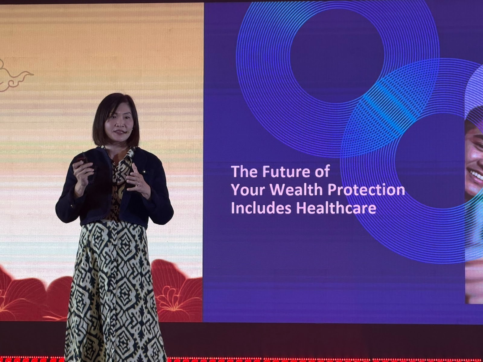 Mylene Ong, Oona’s Group Chief Marketing Officer presenting on stage with a slide reading “The Future of Your Wealth Protection Includes Healthcare” during the event.