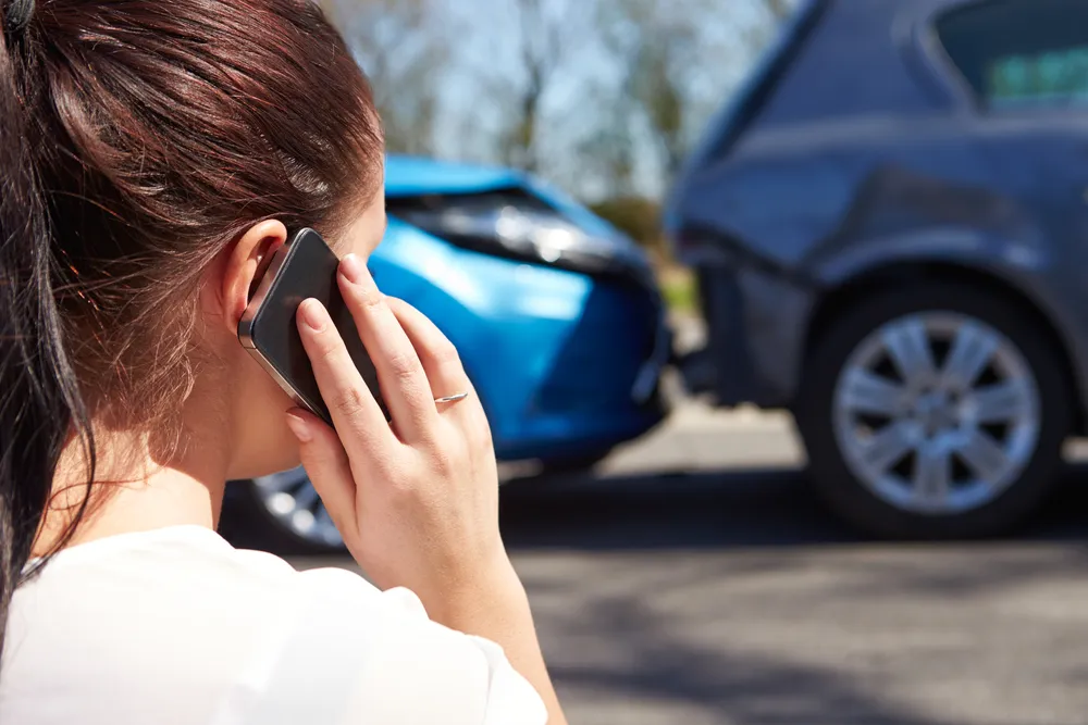 Driver filing car insurance claim form after a vehicle accident in the Philippines